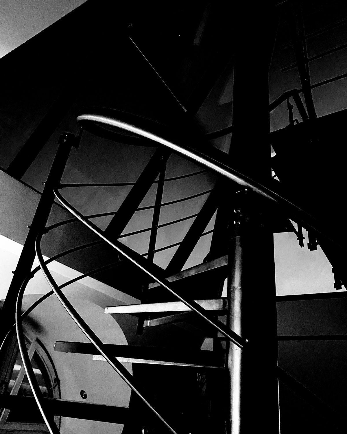Dark staircase with curved railing